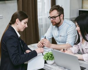 a couple talking to an insurance officer